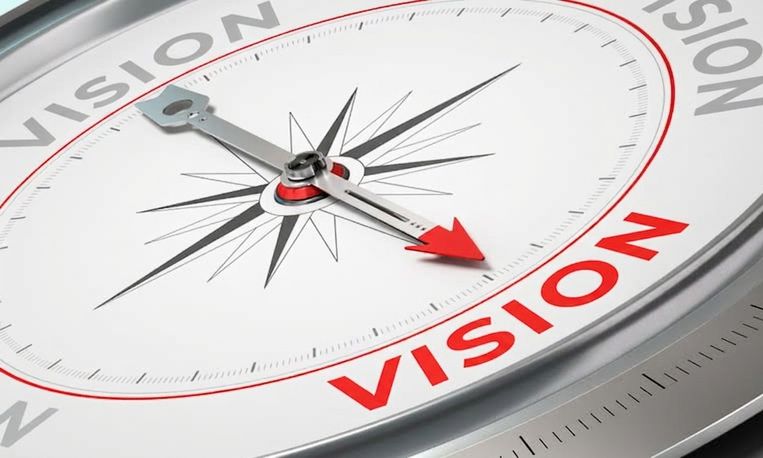 Photo d'une boussole pointant vers le mot vision