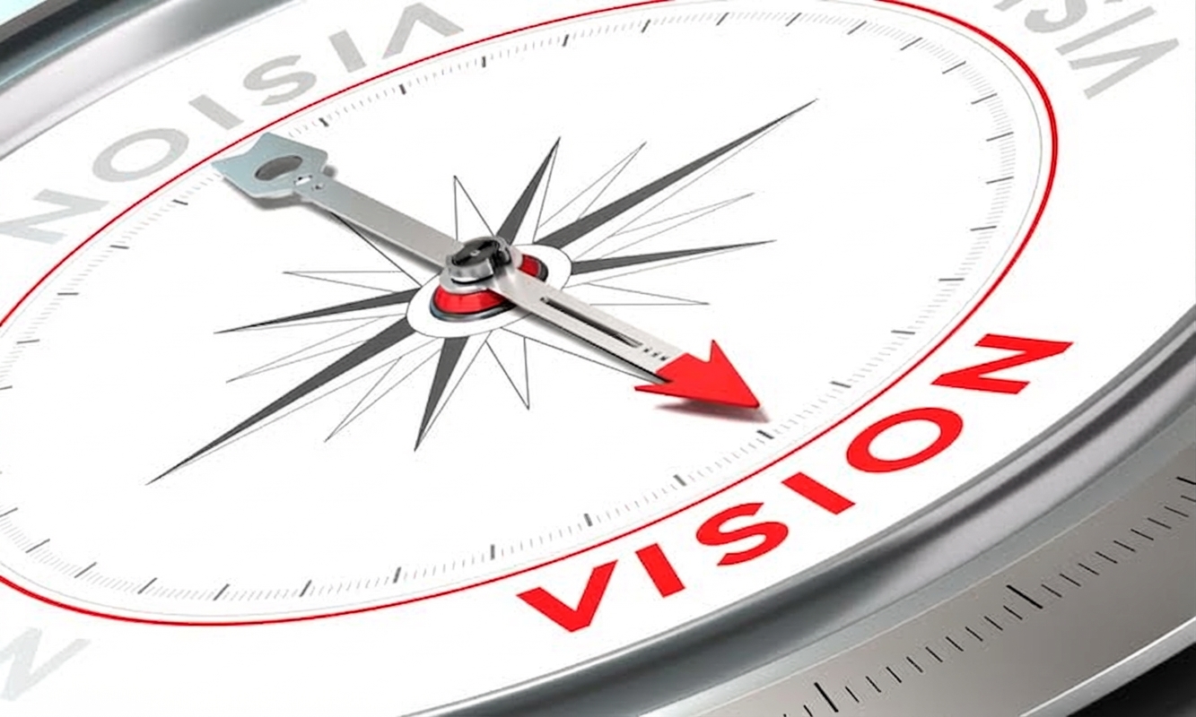 Photo d'une boussole pointant vers le mot vision
