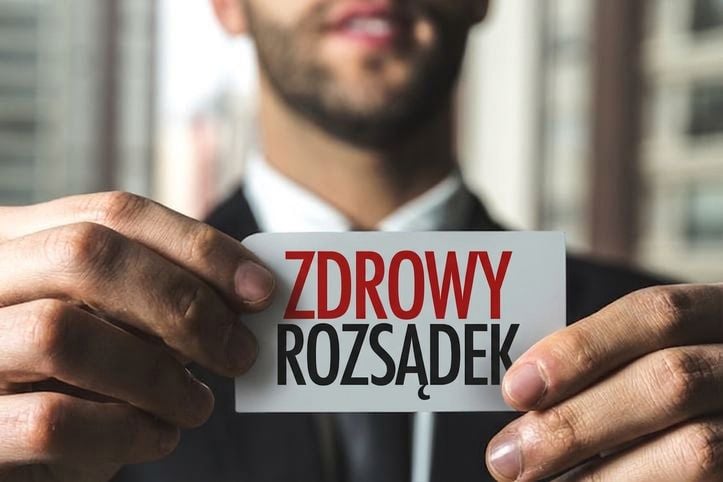 Mężczyzna trzymający etykietę z napisem „zdrowy rozsądek"