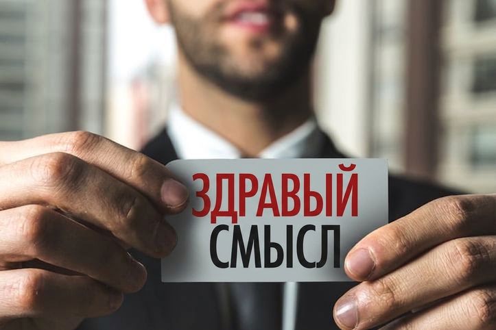 Мужчина держит табличку с надписью «common sense»