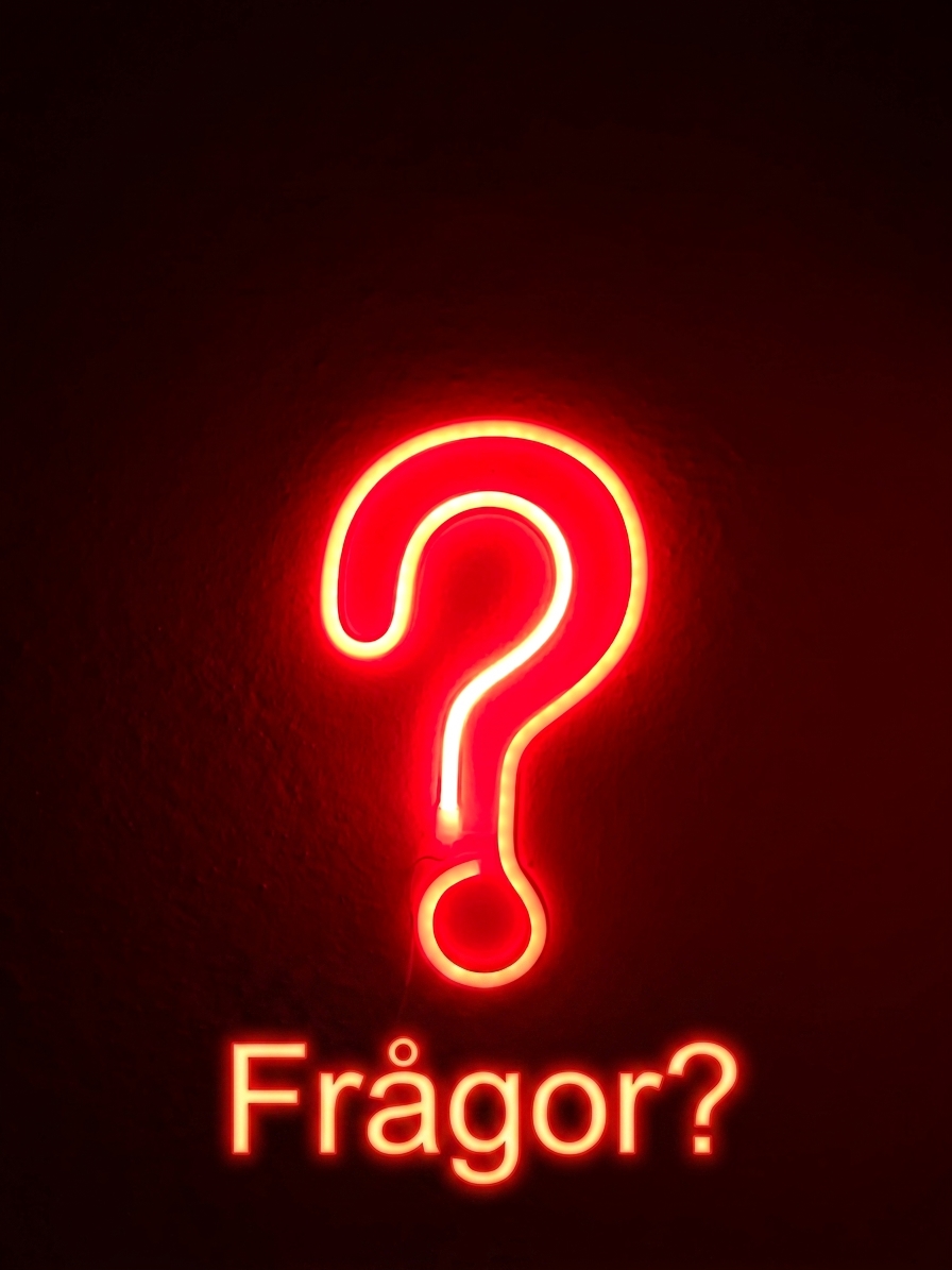 Frågetecken i rött neonljus