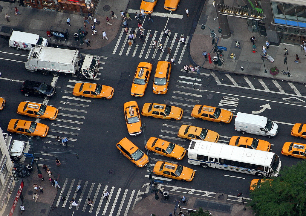 Overhead photograph of cars and taxicabs on a street in New York City.
