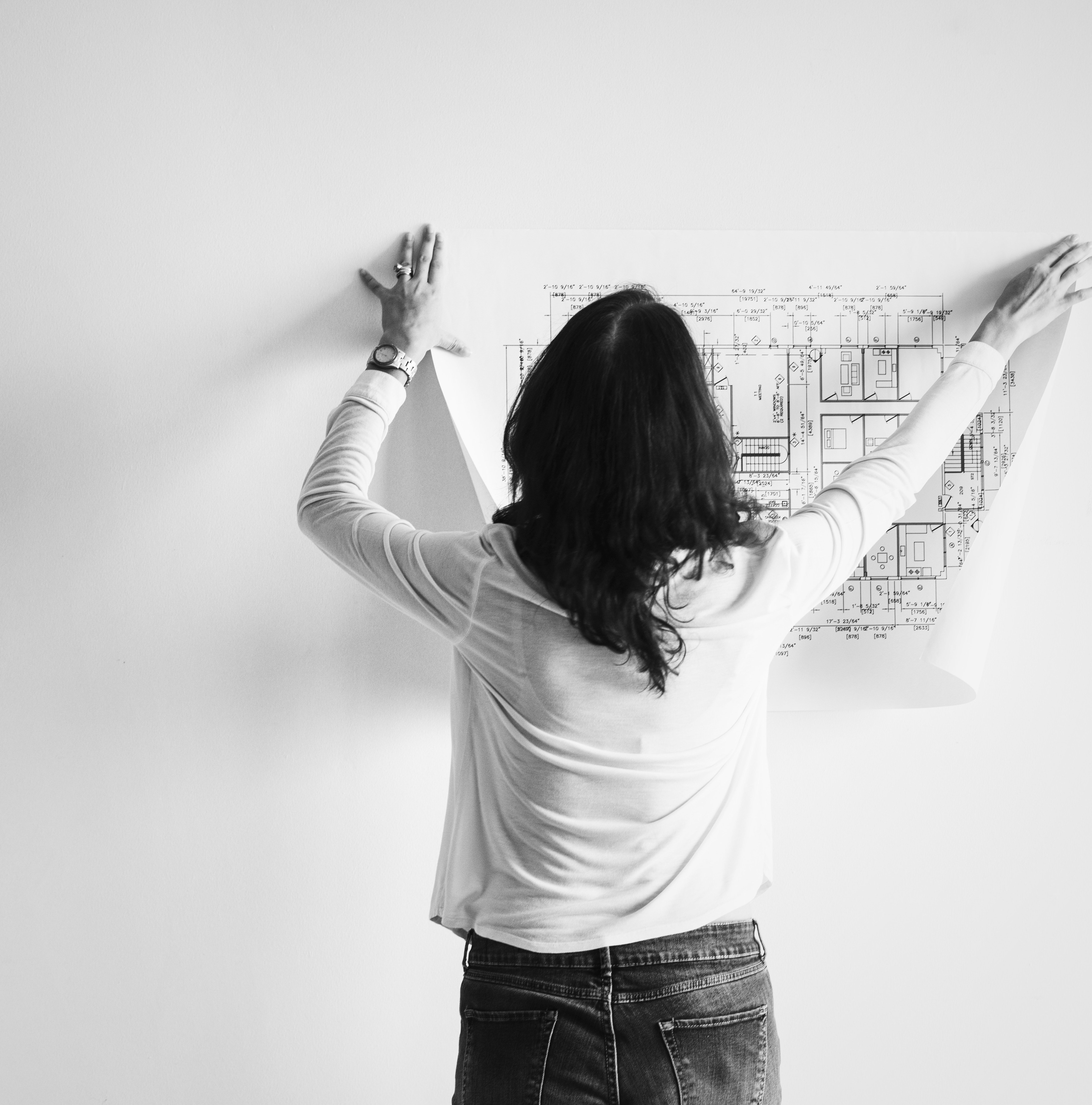 Woman examining blueprints