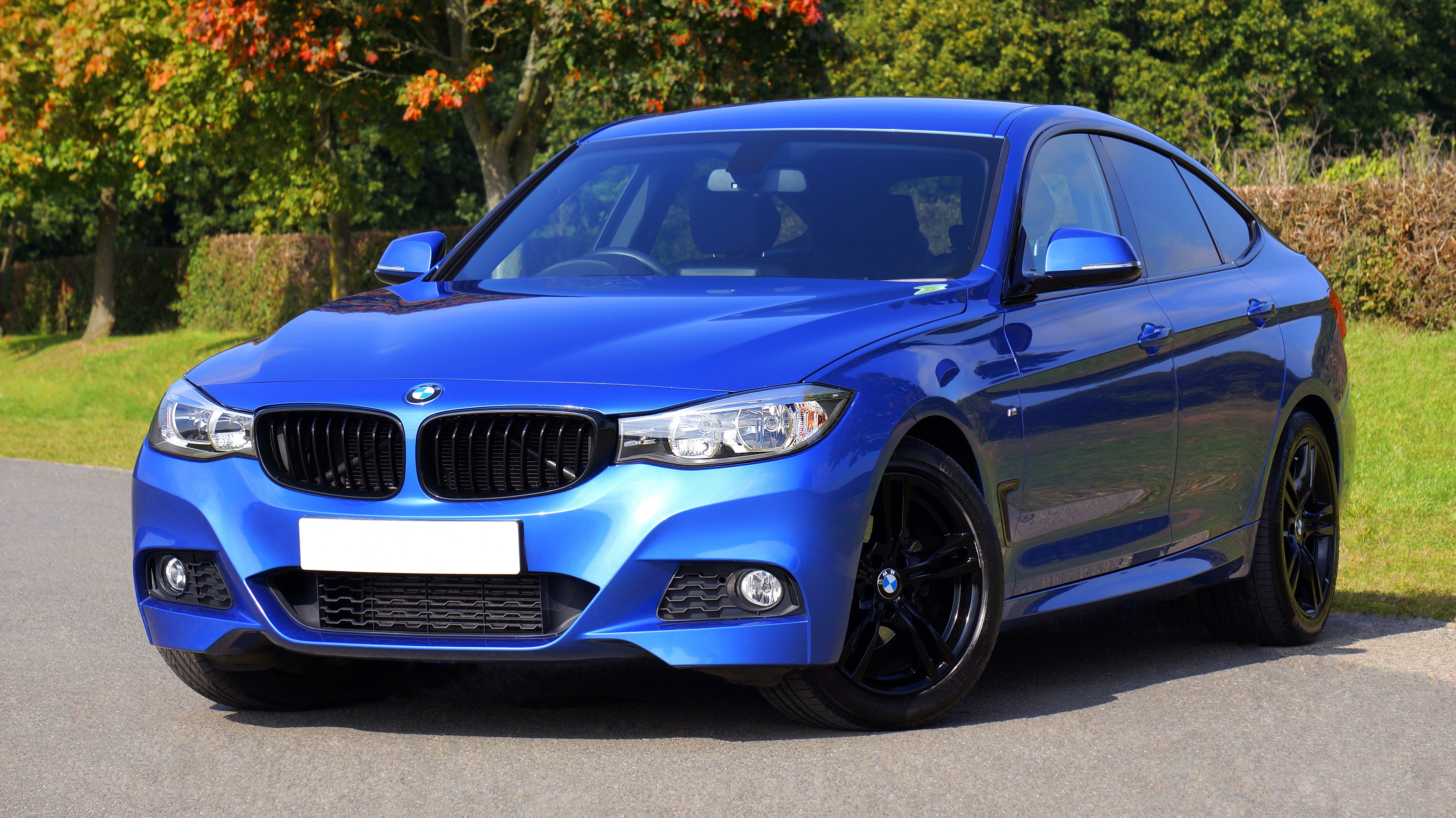 Blue BMW on asphalt