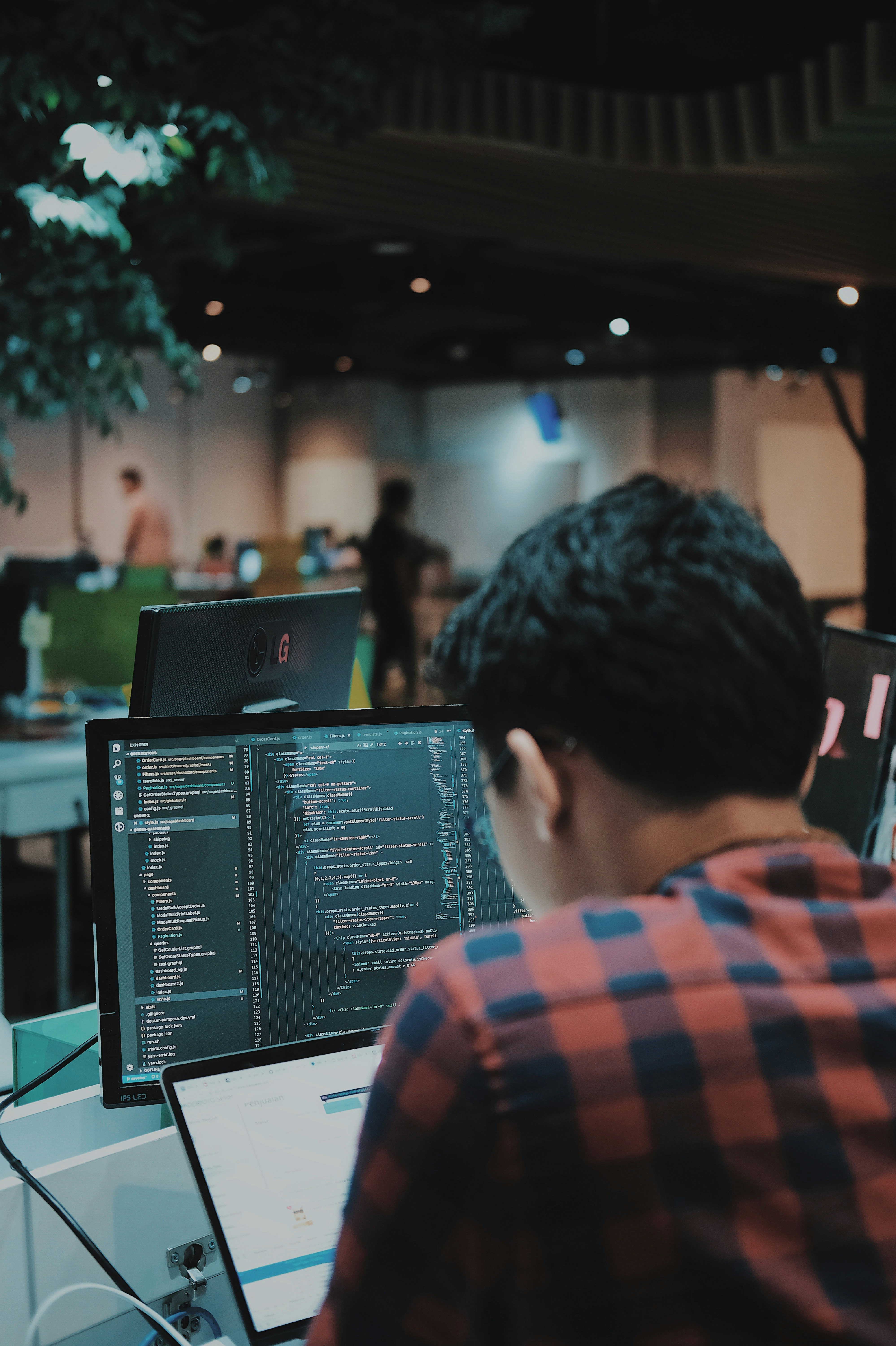 Photo of a person writing code at a computer