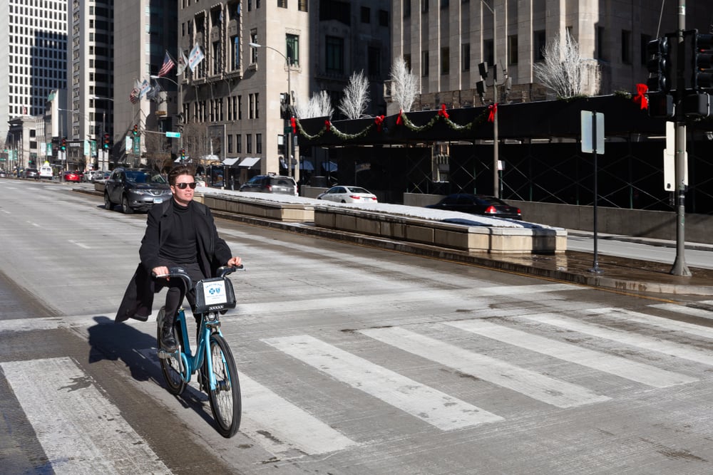 Person riding though town on a Divvy bike