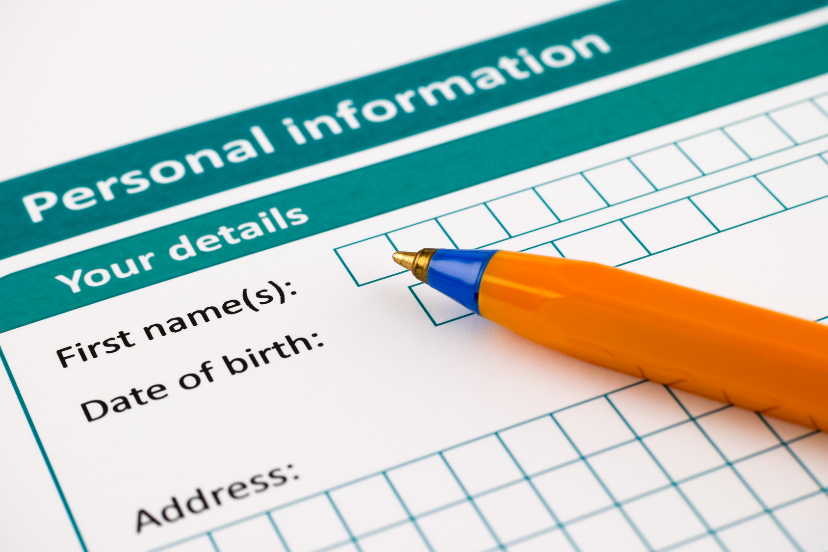 Paper form with space for writing personal information details, and a pen