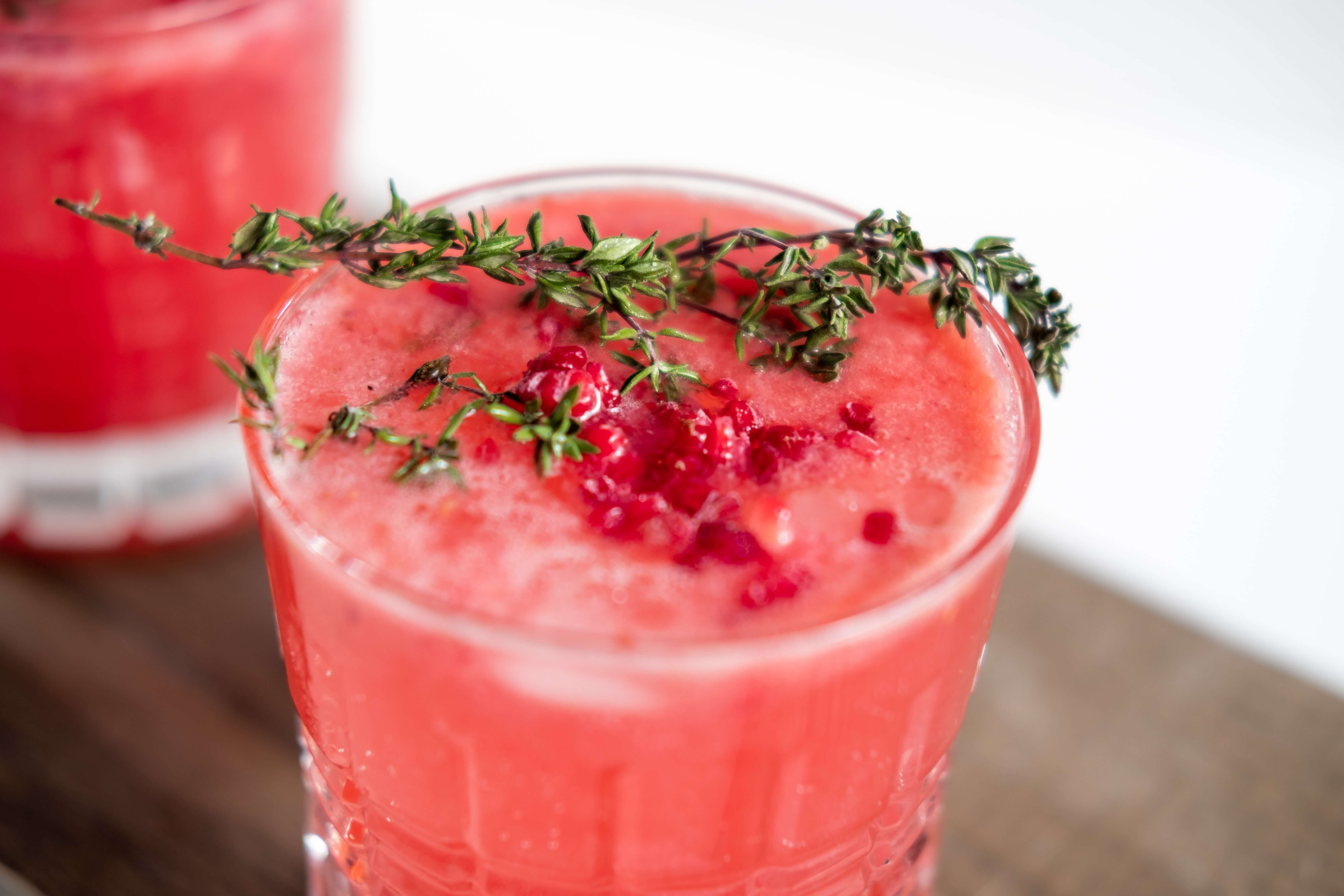 A drink with thyme as a garnish