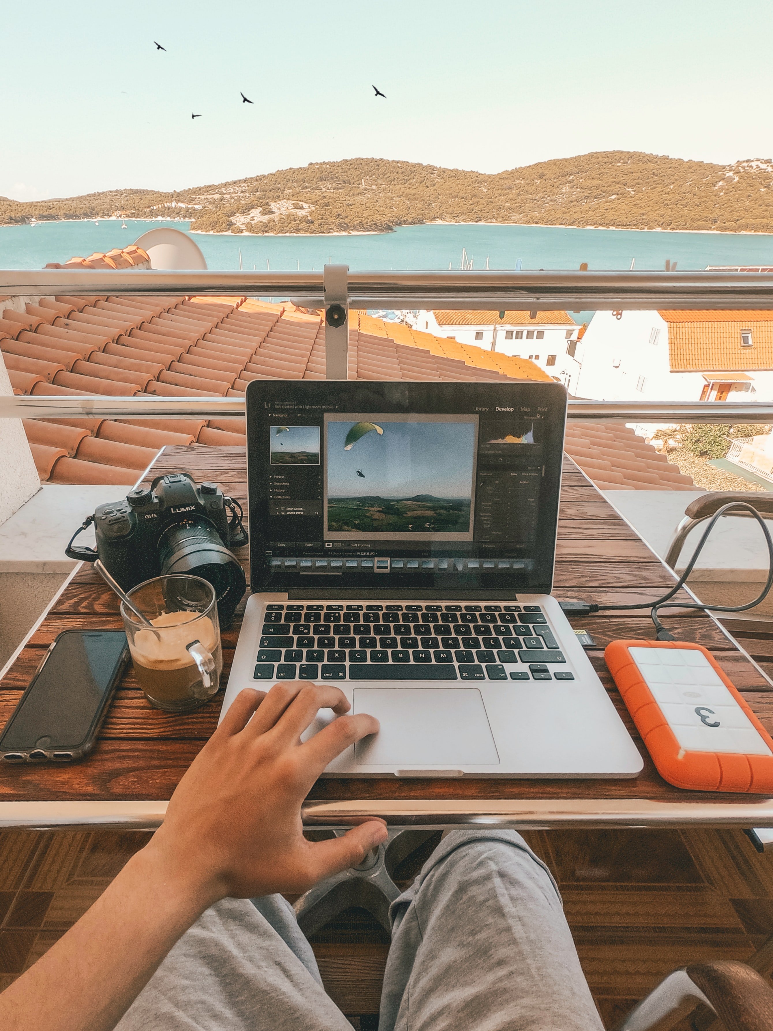 view of a laptop looking across a rooftop and a lake