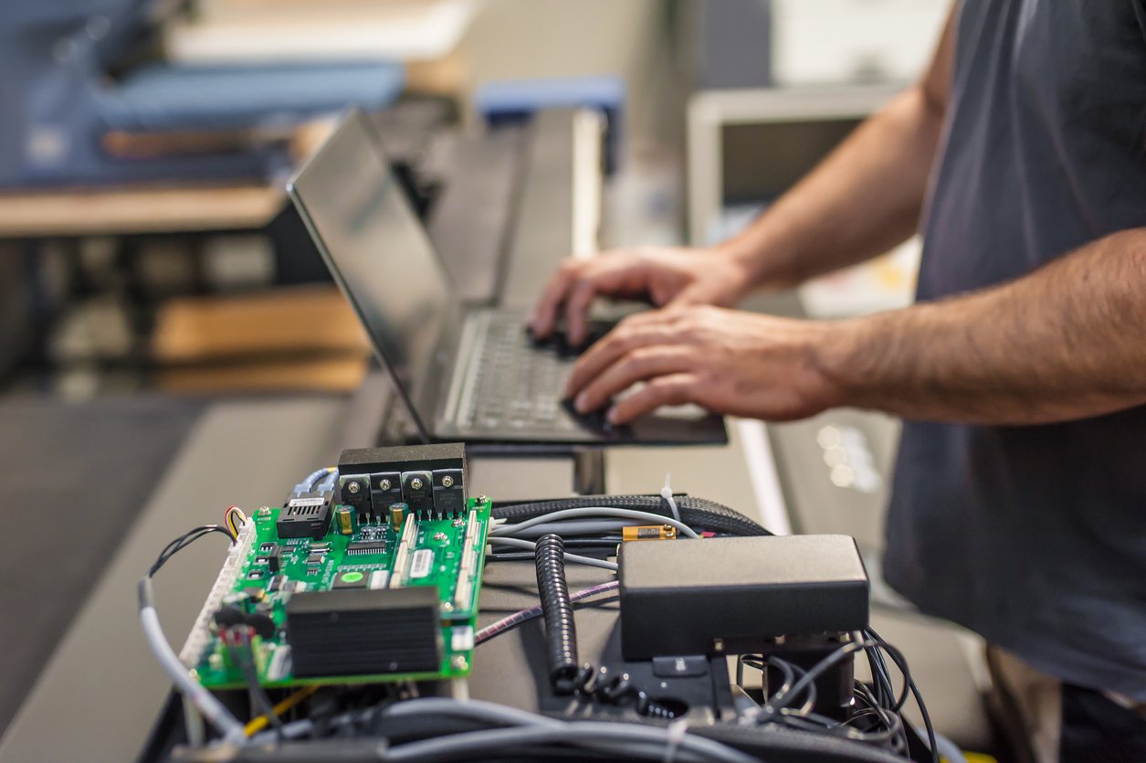 A technician working on a laptop