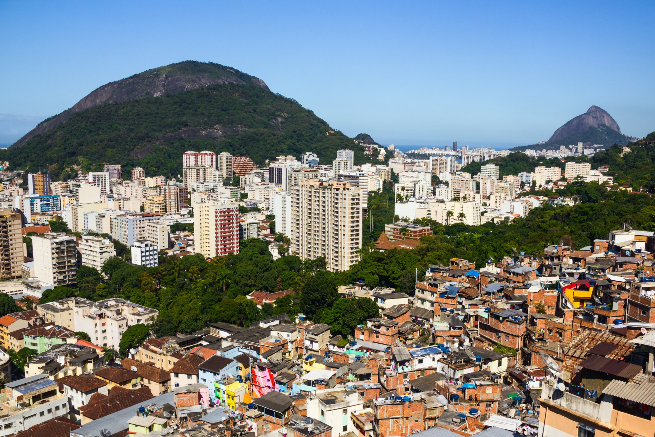 A large city with a mix of high rise buildings and smaller rundown houses.
