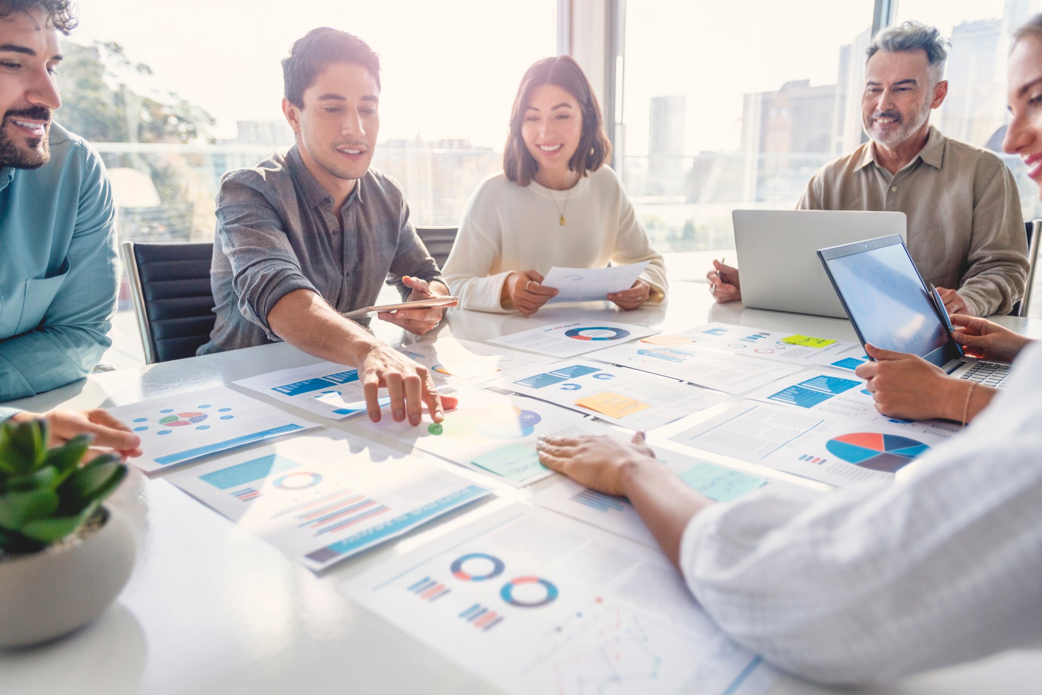 A group of people sitting together at a table planning business strategy.