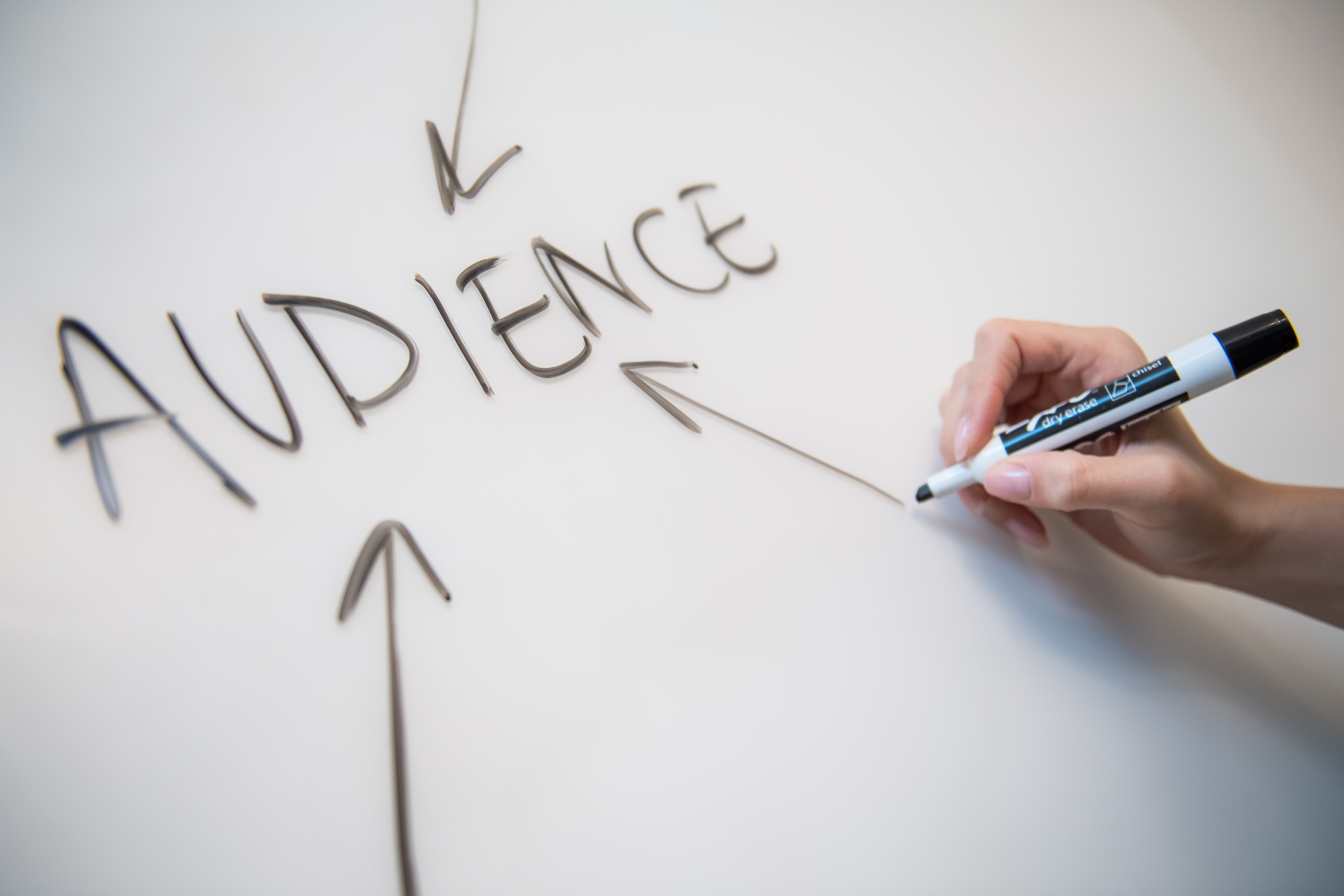 The word audience is written on a whiteboard with arrows pointing to it