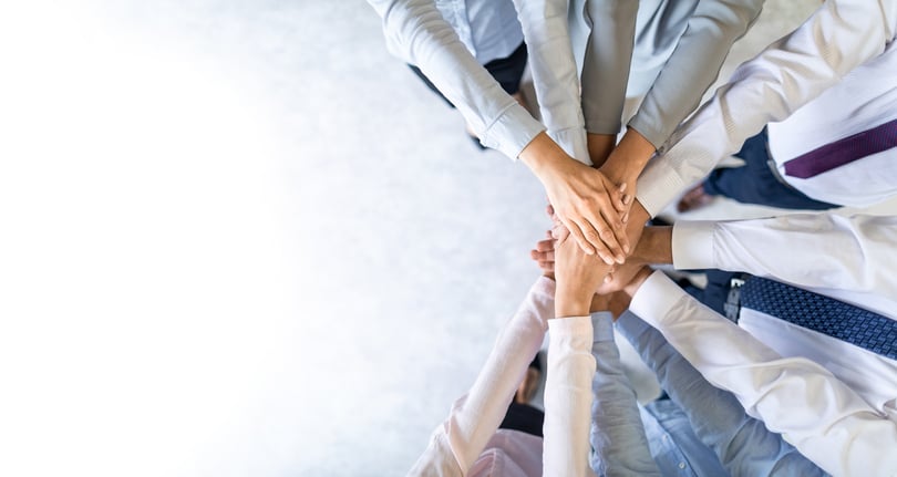 Stack of hands to show unity and teamwork
