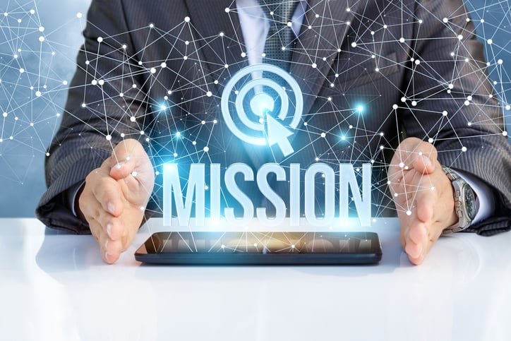 Pair of hands holding the word mission