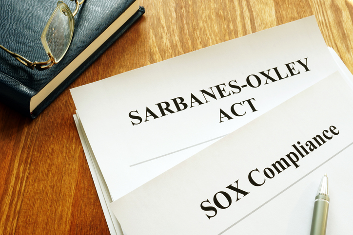A picture of paperwork that has Sarbanes-Oxley Act and SOX Compliance on top