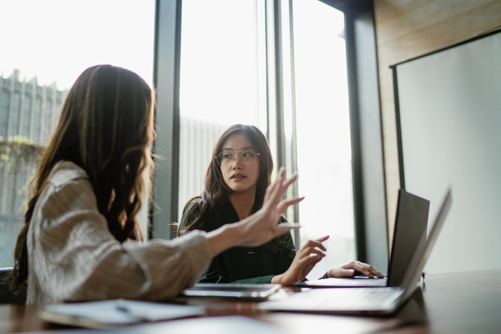 Two business people making business decisions in a meeting room.