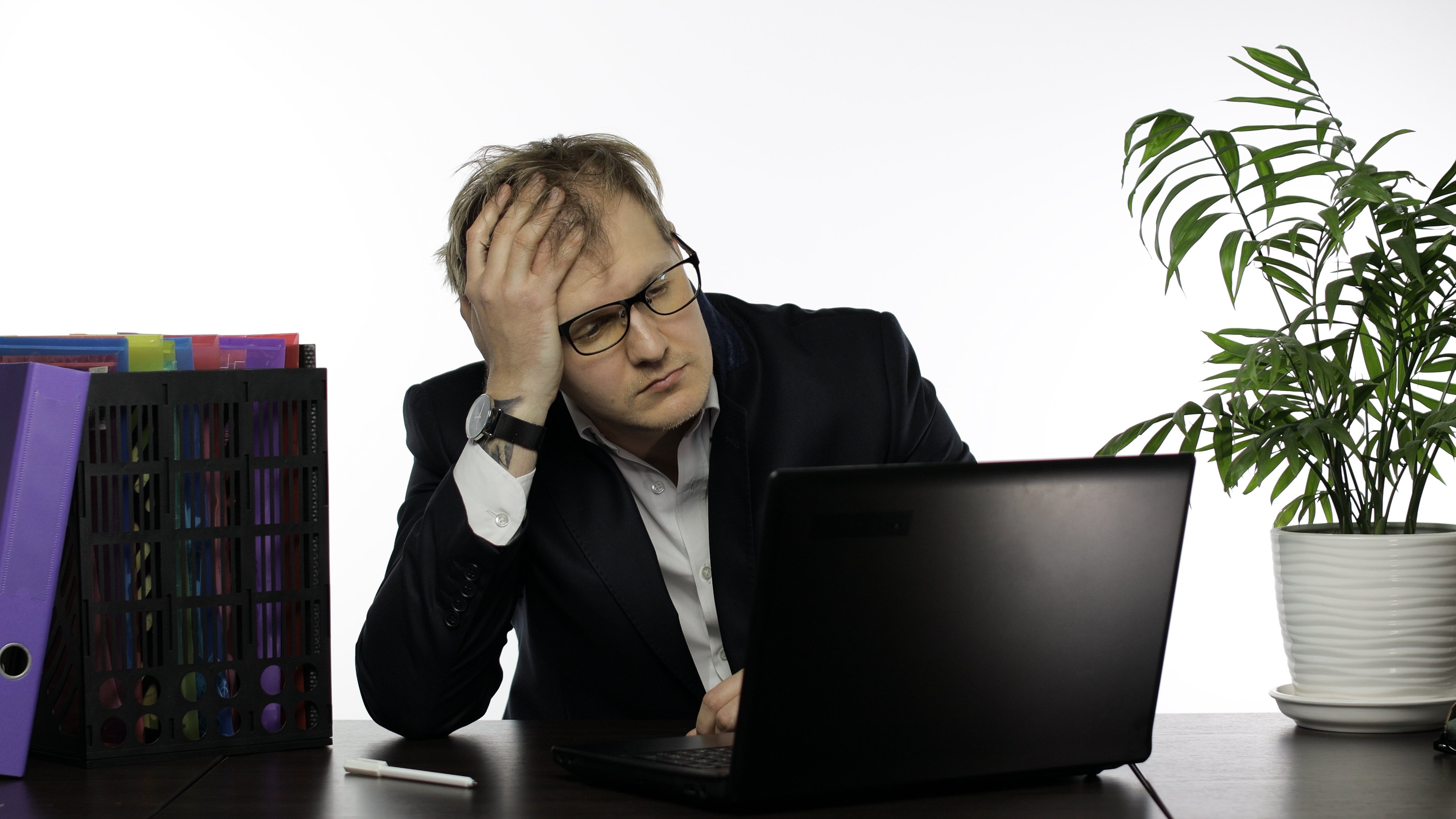 Image of a very frustrated data scientist in front of a laptop.