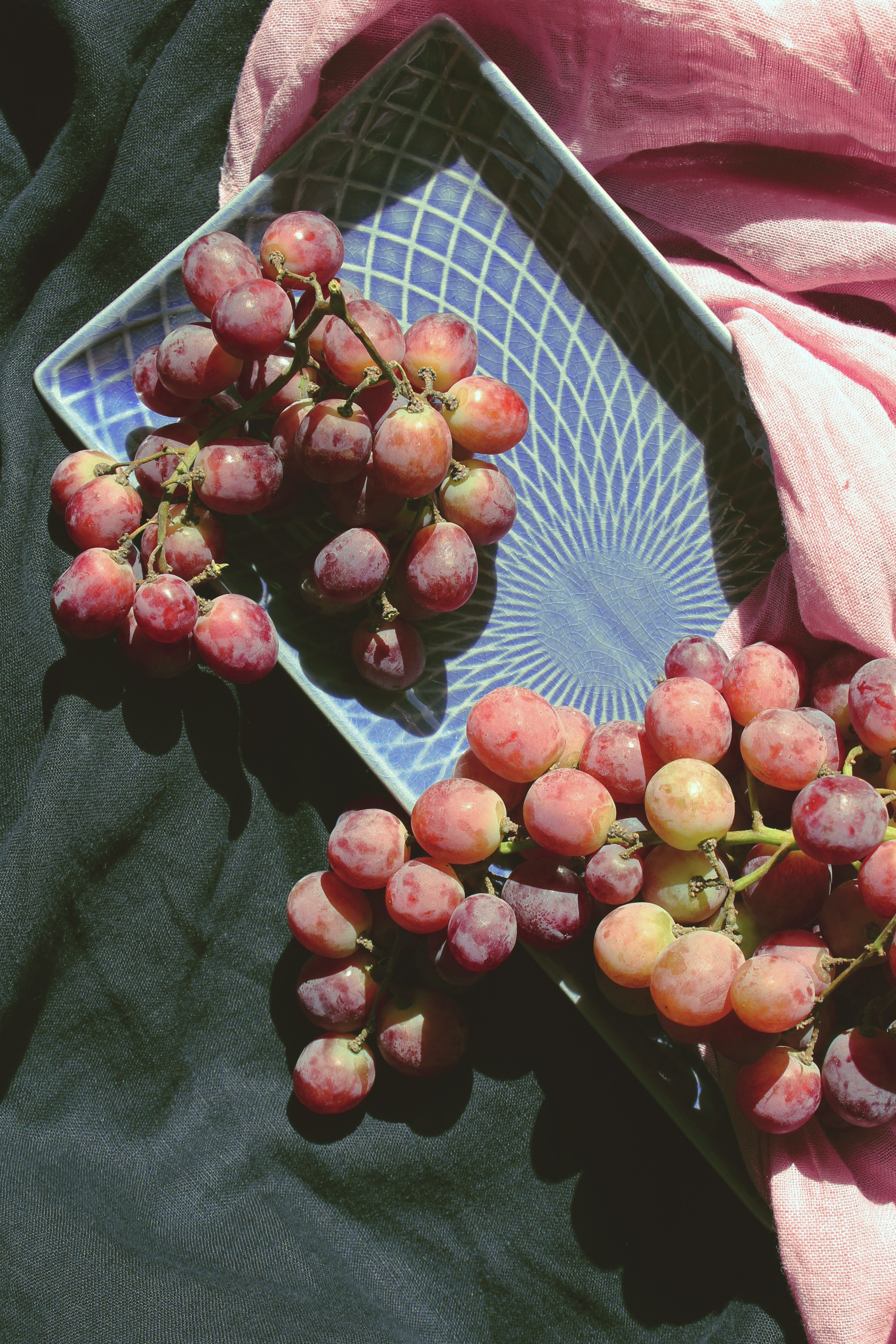 Photo by Olesia Bahrii on Unsplash - two bunches of grapes