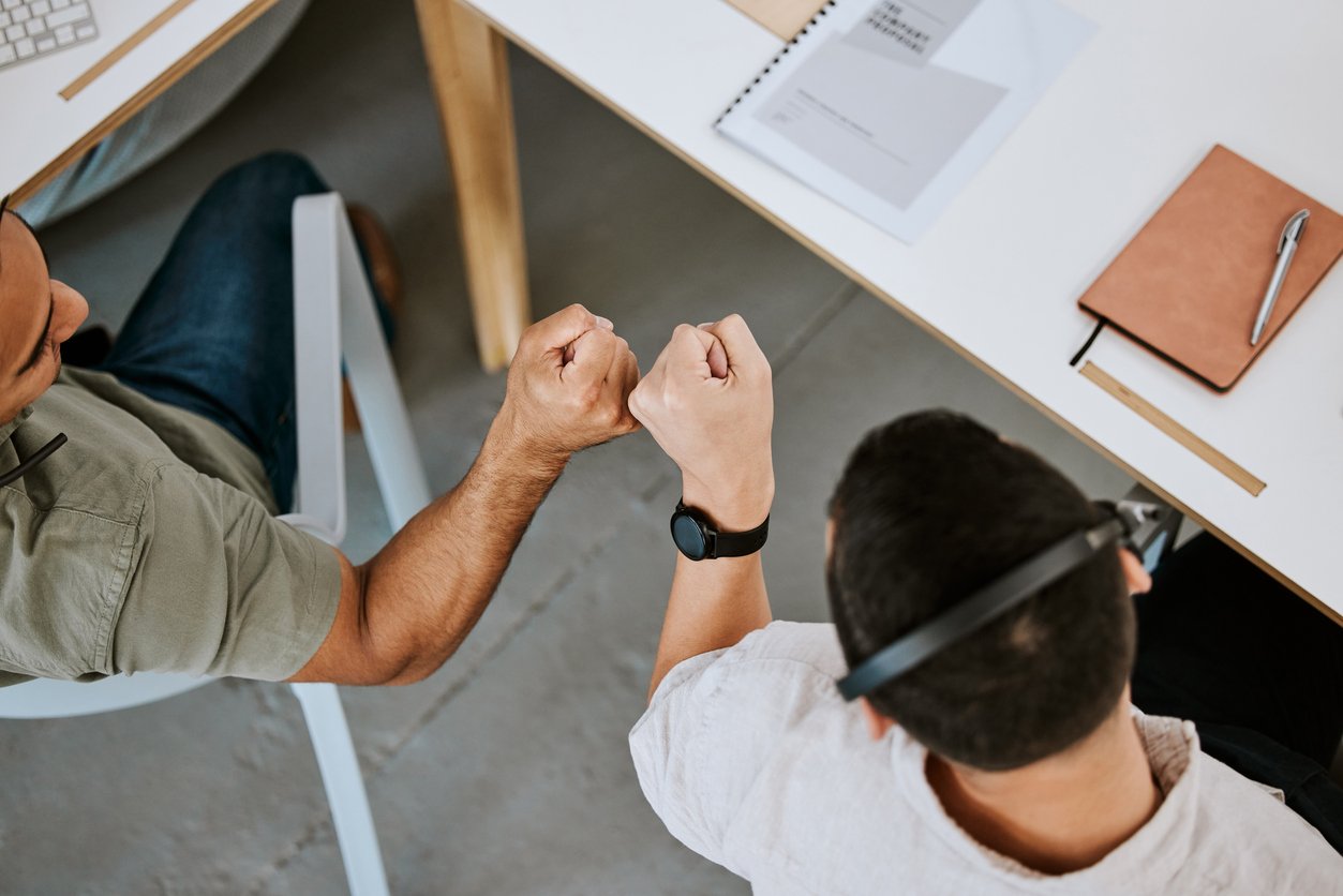Excited call centre agents, fist bump