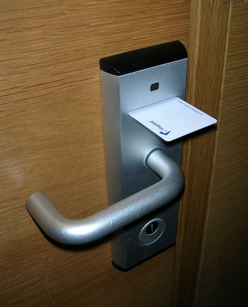 Picture of an electronic keycard inserted in the door handle to gain access into a room.