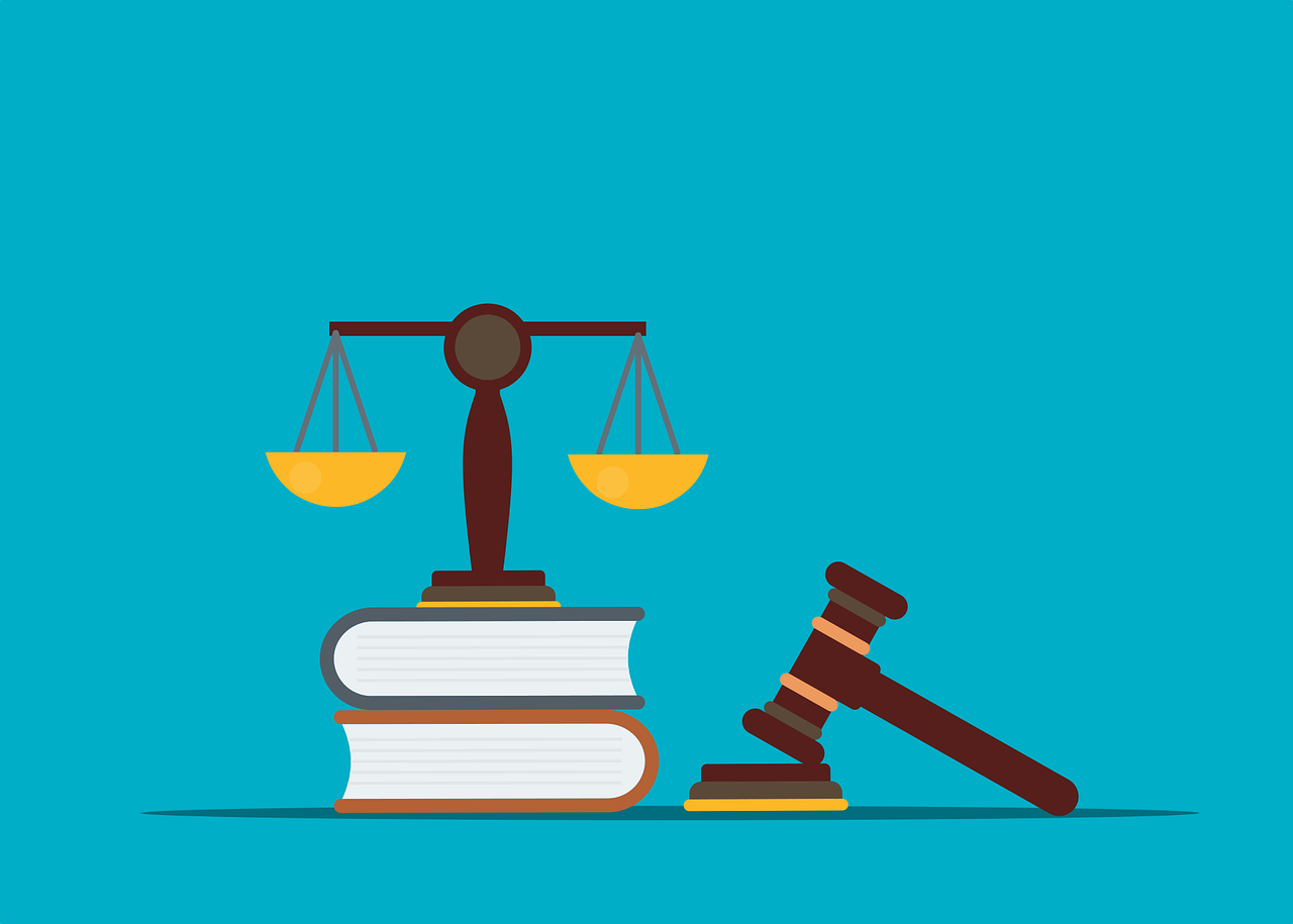 Illustration with a gavel next to law books and a set of balance scales representing judgement