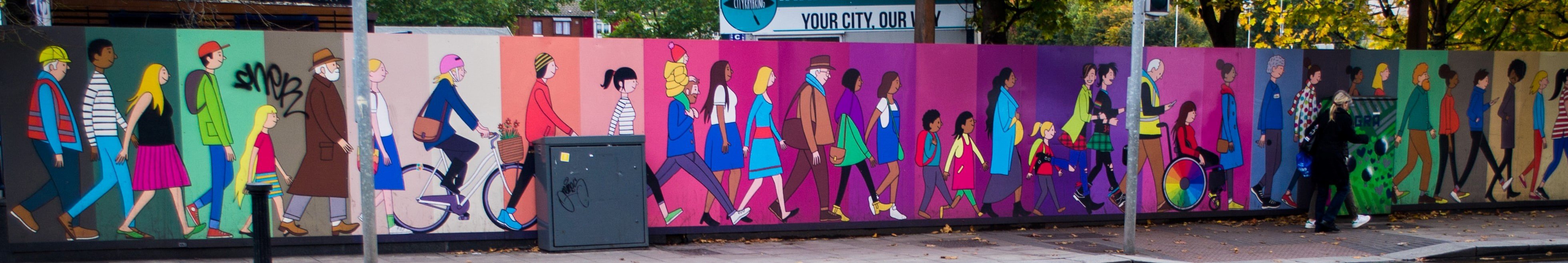 Photo of a mural with illustrations of people from all walks of society walking.