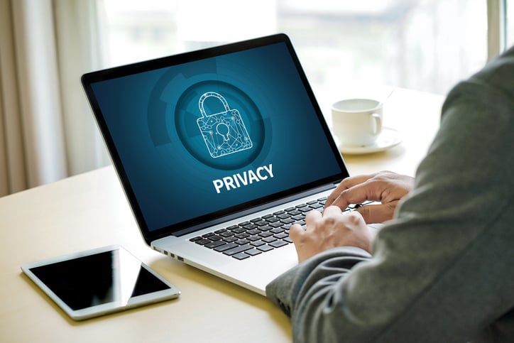 Typing on laptop with privacy screen