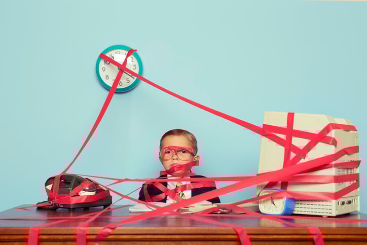 Young boy wrapped in red tape