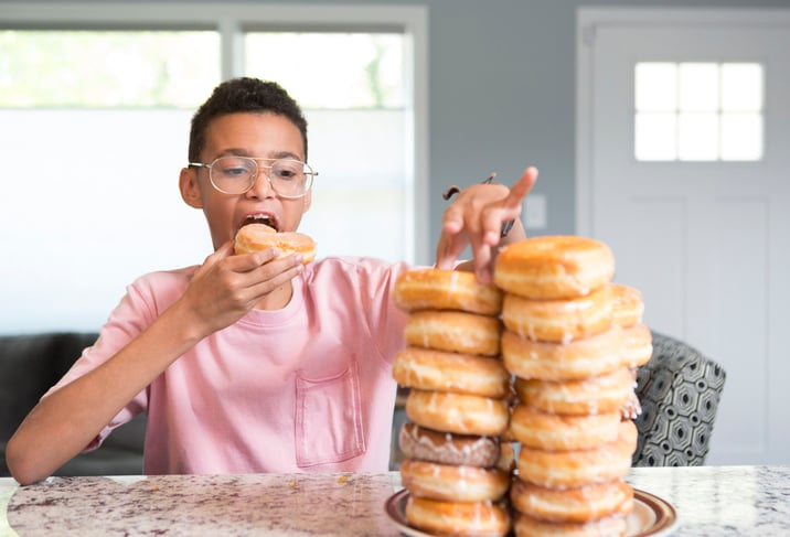 Boy eating donut tower