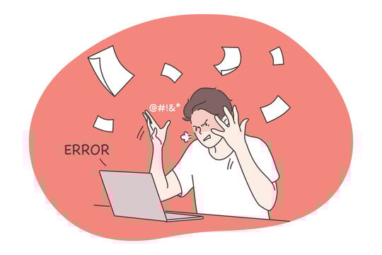 A programmer is frustrated looking at the screen, and has tossed all the papers on the desk.