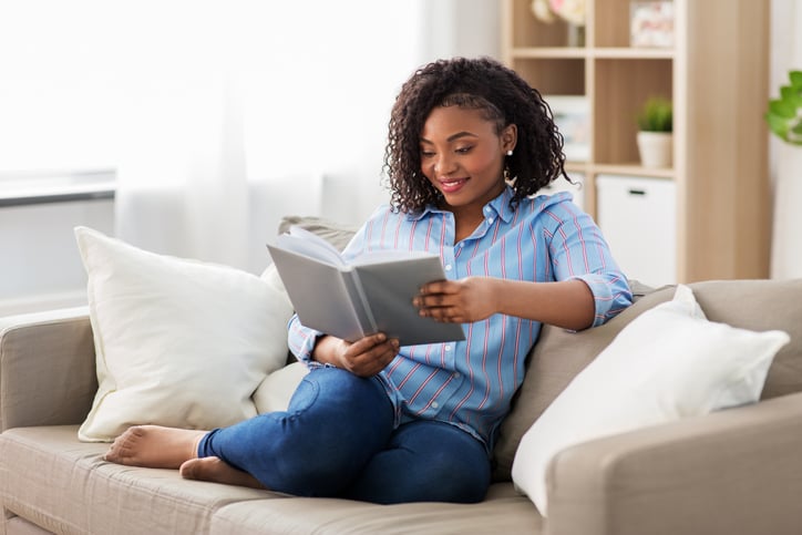 Woman reading a book at home