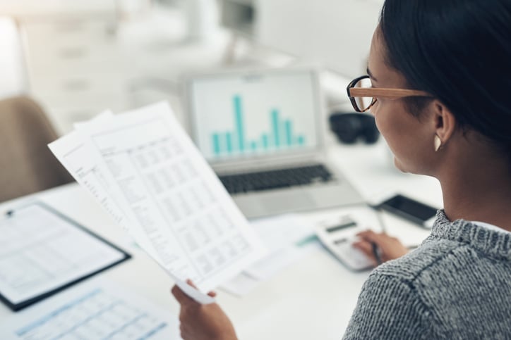 Business woman calculating finances in an office