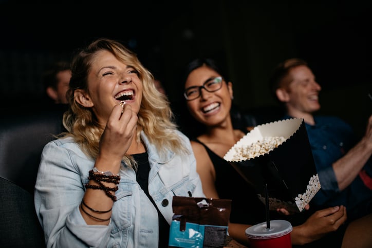Young woman with friends watching a movie