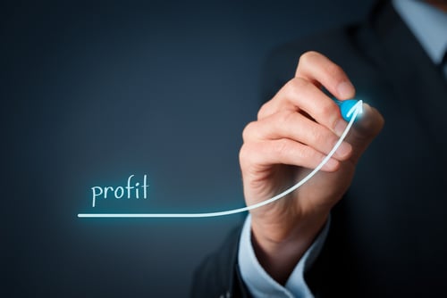 Image of a man drawing an upward trending line representing profit