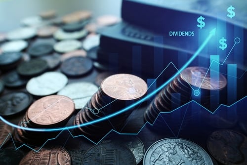 Image of coins, with the foreground showing line chart trending upwards