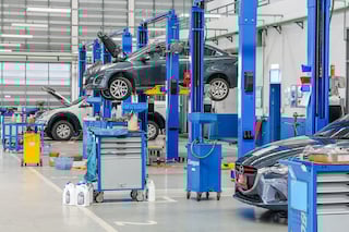 A photo of cars in a mechanic shop