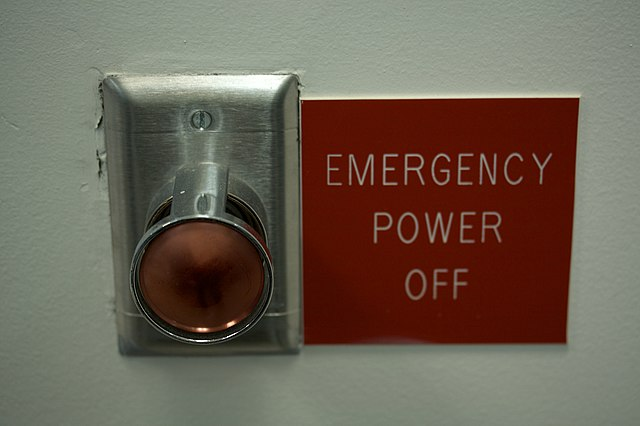 Image of a big red button with an "Emergency power off" sign next to it