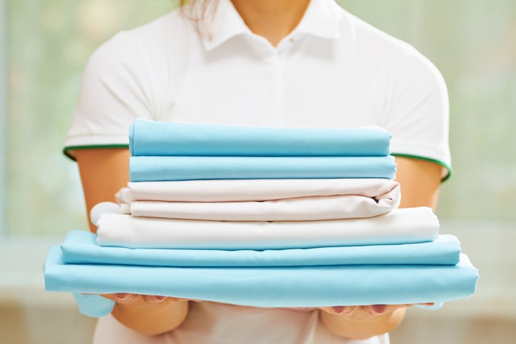 Person holding clean, folded clothes