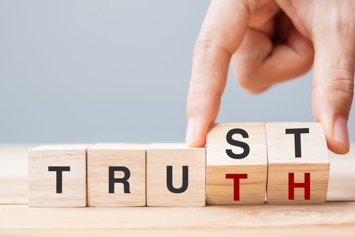 The word "Truth" and "Trust" being written out by wooden blocks