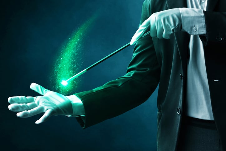 Magician with a wand performing tricks