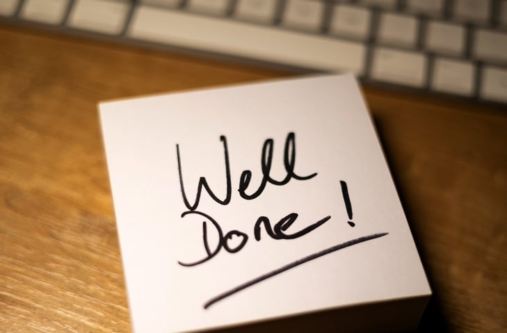 Image of a card with the words "well done" written on the front