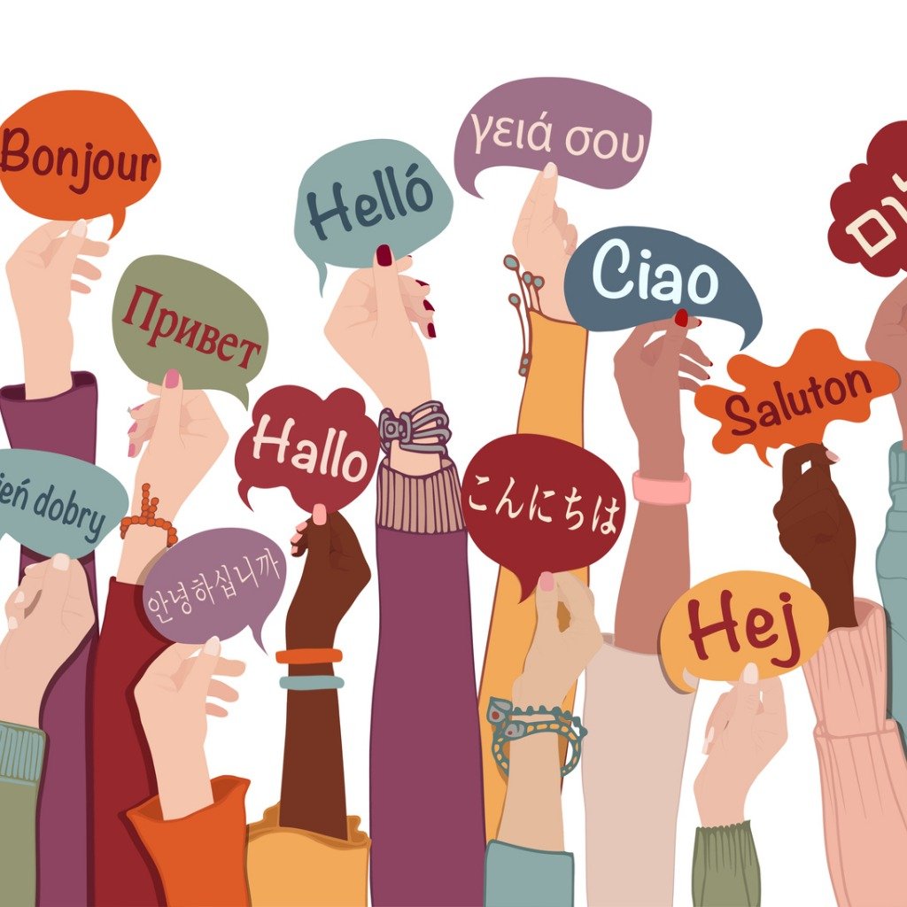 Hands holding up signs with the word "hello" in many languages
