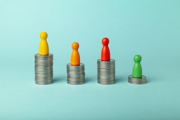 Image of coins stacked to different heights, and different color game pieces on top of each stack