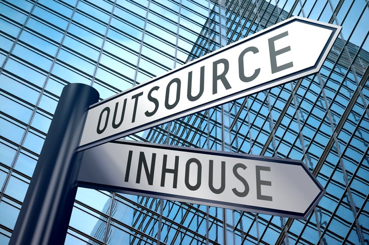 A signpost showing two possible directions - outsource or inhouse