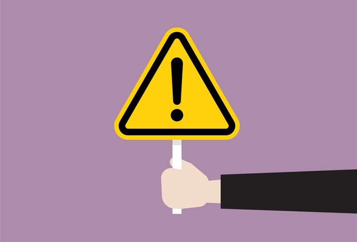 Illustration of a hand holding a yellow triangular warning sign
