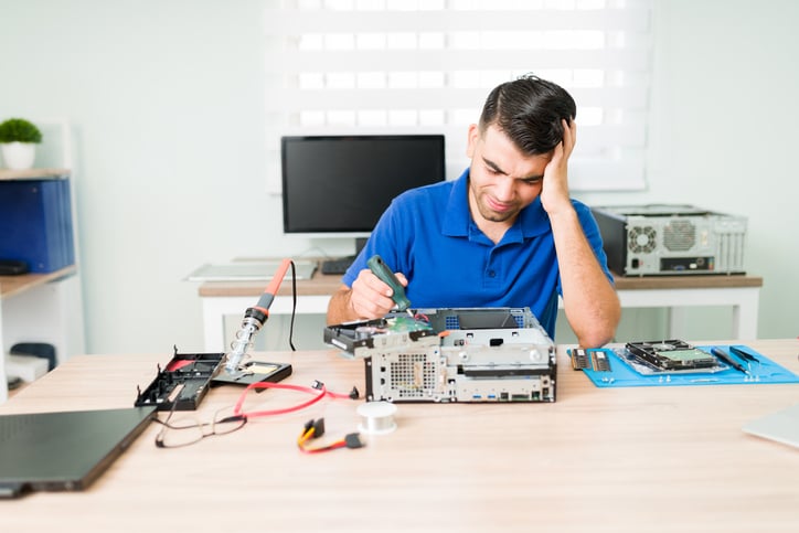 A technician feels frustrated after he opens up a computer casing.