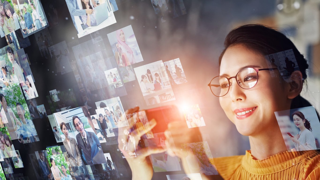 A person uses their mobile device to view and share photos.