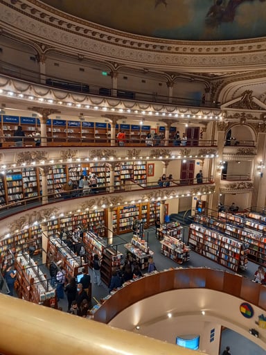 A large multi-floor library, each floor full of bookshelves.