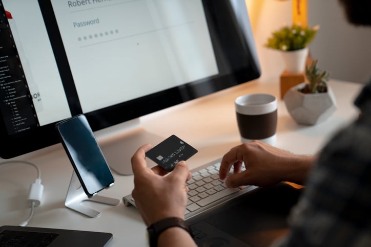 A person uses their credit card to make a purchase online.